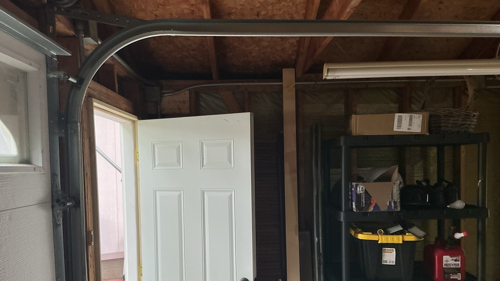 Same-day garage door repair in Moline, IL, showing the curved garage door track and supporting hardware inside a residential garage.