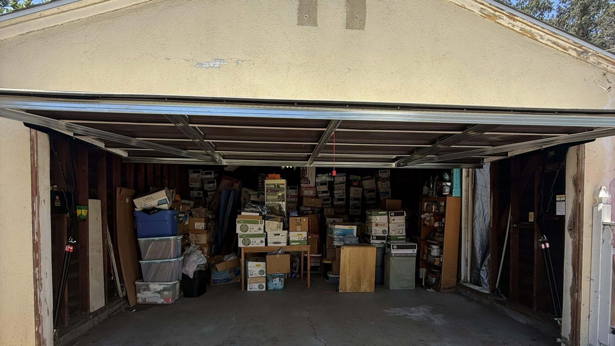 New garage door installation in Santa Ana, CA, showing a partially open sectional garage door and metal support framing.