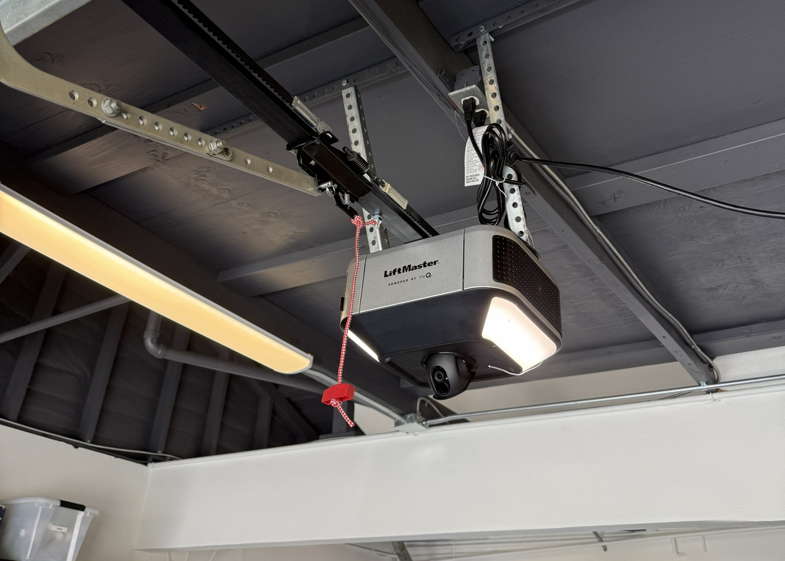 Garage door opener installation in Santa Ana, CA, showing a LiftMaster opener with built-in camera, LED lights, and belt-drive rail.